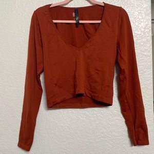Cropped long sleeve v neck shirt from Urban Outfitters- Burnt orange in color